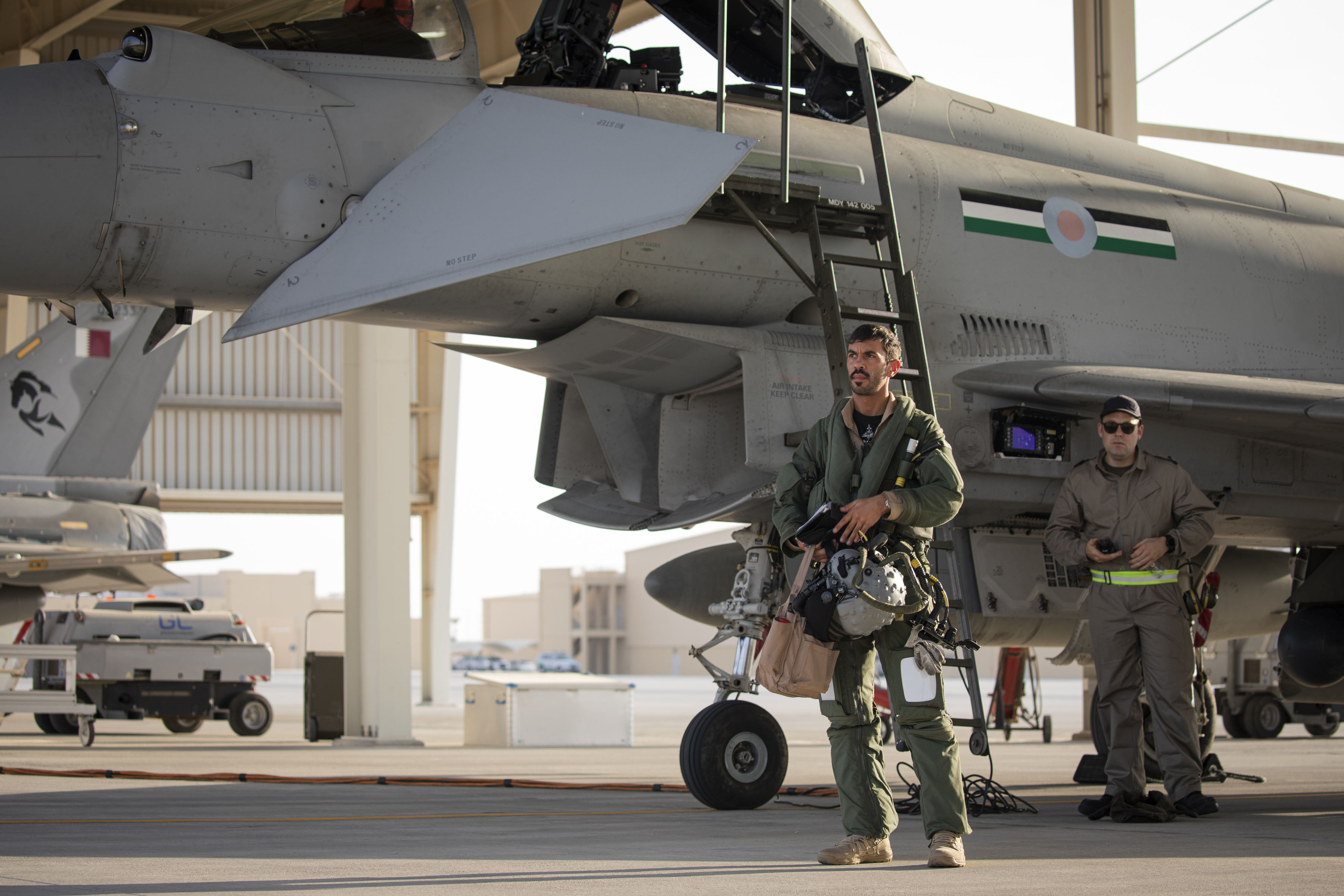 Image shows personnel walking by a Typhoon aircraft on the airfield.